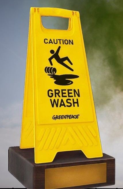 Hazard sign saying that green washing is happening.
